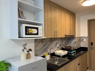 a kitchen with a sink and a microwave at Shore 2 Residences RM 19106 Pool View by Prime Stay MOA in Manila