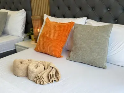 a white bed with pillows and a towel on it at Shore 2 Residences RM 19106 Pool View by Prime Stay MOA in Manila