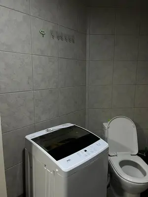 a small bathroom with a toilet and a sink at H Cloud Suites Monarch Parksuites near MOA and Casino City in Manila