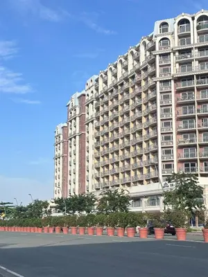 a large apartment building on the side of a street at H Cloud Suites Monarch Parksuites near MOA and Casino City in Manila