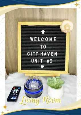 a sign that says welcome to cityhaven unit with a table with a remote at Condo with Pool and Balcony near Megamall Ortigas Center in Manila