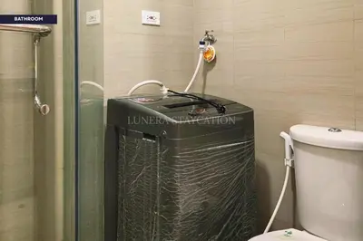 a bathroom with a trash can and a toilet at City View Staycation Near Mall of Asia and Airport in Manila