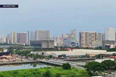 a view of a city with a river and buildings at City View Staycation Near Mall of Asia and Airport in Manila