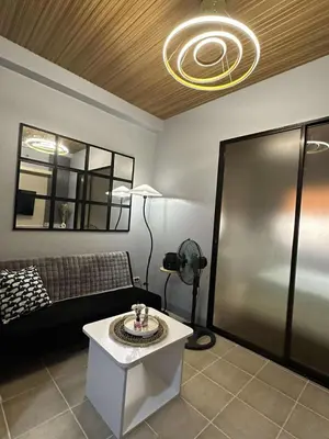 a living room with a couch and a table at Stay at FB Harrison near World Trade Center MOA and NAIA in Manila