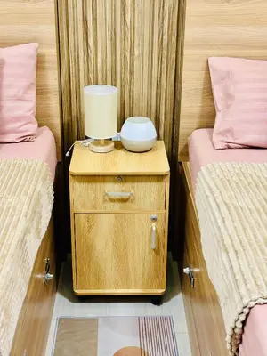 a room with two twin beds and a lamp on a night stand at Shore 2 Residences Tower 1 in Manila