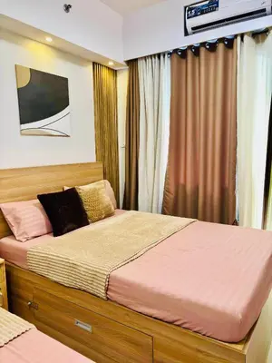 a bedroom with a large bed on a boat at Shore 2 Residences Tower 1 in Manila