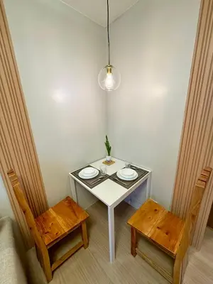 a white table with two plates on it and two chairs at A and A Place - The Hive C - Free Parking in Taytay