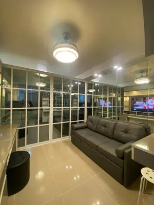 a living room with a couch and a television at Shore 1 Residences Tower D Pasay in Manila