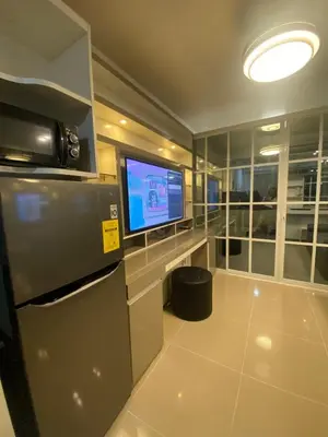 a room with a tv and a large screen at Shore 1 Residences Tower D Pasay in Manila