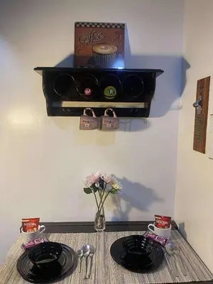 a table with two plates and a box on a wall at Cozy Haven Across Terminal 3 in Manila
