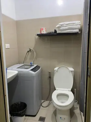 a bathroom with a toilet and a sink at Shore 1 Spacious Smart Home 3C in Manila