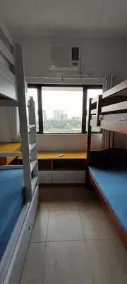 a room with two bunk beds and a window at Dagos Studio City Filinvest Alabang in Manila