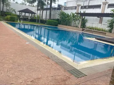 a large swimming pool with blue water in a building at Dagos Studio City Filinvest Alabang in Manila