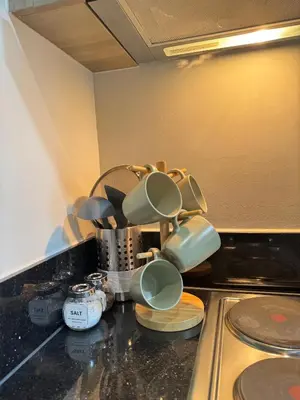 a bunch of cups sitting on top of a kitchen counter at Erin Serenity Harbor in Manila