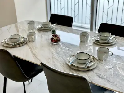a table with plates and napkins on top of it at Modern 3BR 180 Degree Seaview Beside Okada Manila 14 in Manila