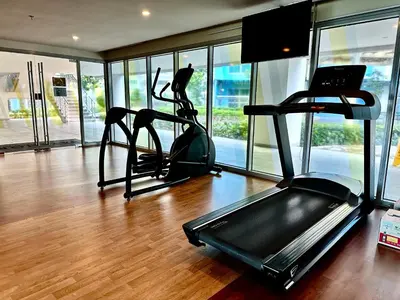 a gym with two exercise bikes and a treadmill at Modern 3BR 180 Degree Seaview Beside Okada Manila 14 in Manila