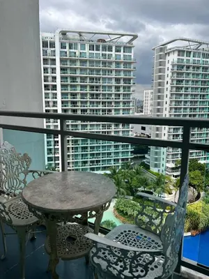 a balcony with a table and chairs and buildings at Azure Resort and Staycation by Miss Angie in Manila