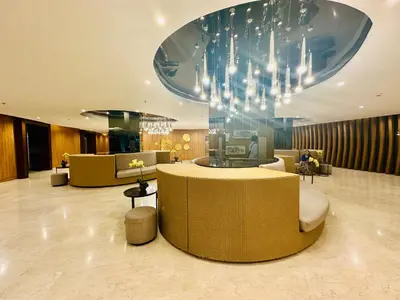 a hotel lobby with a chandelier and a waiting room at Shore Bliss Staycation MOA in Manila