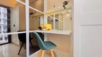 a room with a desk and a green chair at 1 Bedroom Apartment in Pasay near MOA in Manila