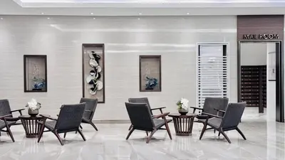 a room with chairs and tables and a wine cellar at Cozy 1 Bedroom near MOA in Manila
