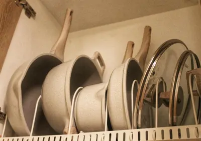 a bunch of pots and pans hanging on a wall at Japandi - Inspired Staycation MOA Pasay City in Manila