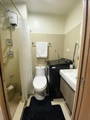 a small bathroom with a toilet and a sink at Cabin and a cozy stay near MOA in Manila