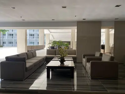 a living room with couches and a coffee table at MOA Home For Family Trips & Getaways Kitchen-505 in Manila