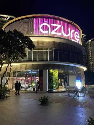 a large building with a large neon sign on it at Condo in Paranaque City Homes Azure in Manila