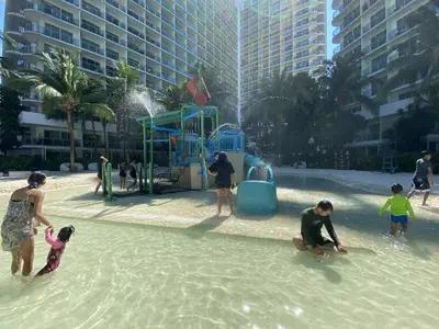 a group of people playing in the water at a playground at Condo in Paranaque City Homes Azure in Manila