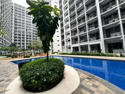 a palm tree in front of a large building at Room 1469 Shore 2 Residences Near Airport, MOA by Prime Stay MOA in Manila