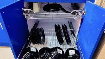 a drawer full of utensils in a blue cabinet at 2 Bedroom Rental Apartment in Pasay in Manila