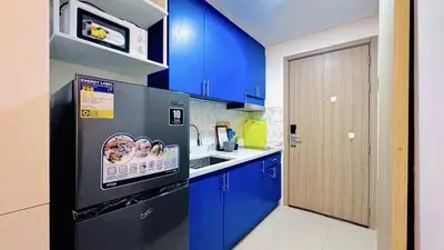 a kitchen with blue cabinets and a black refrigerator at 2 Bedroom Rental Apartment in Pasay in Manila