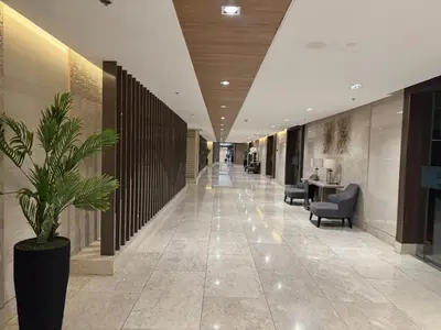 a hallway with a potted plant in a building at Room 1691 Shore 3 Residences infront of SM MOA by Prime Stay in Manila