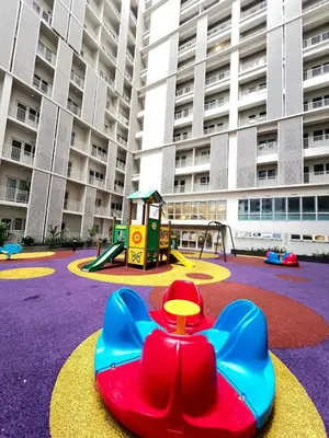 a playground in front of a large apartment building at Luxe 1BR Condo - Near BGC & Venice Grand Canal in Manila
