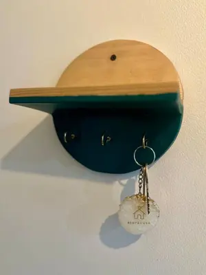 a hat hanging on a wall with a key at Captivating Crib in the Metro in Manila