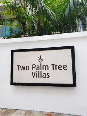 a sign that says two palm tree villas on a wall at Layover Stay Condotels at Two Palm Tree Villas in Manila