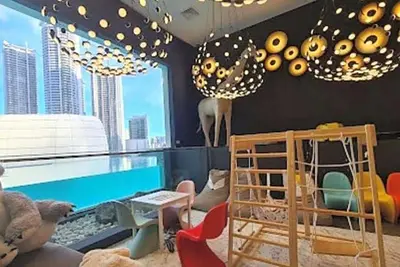 a childrens room with a pool and a table and chairs at Novotel Rockwell View Hotel Residences in Manila