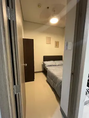 a bedroom with a bed and a door to a room at The Calm Corner - S Residences Tower 2 in Manila