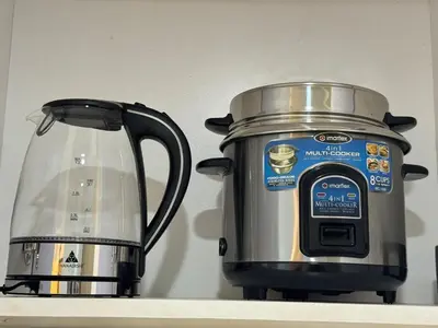 a slow cooker and a tea kettle on a shelf at Sunny side Cityscape C2 RM 1716 Shore Residences by Prime Stay MOA in Manila