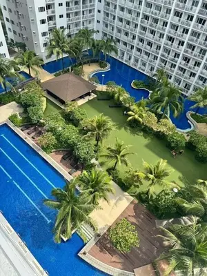 an aerial view of a resort with palm trees and a swimming pool at Twin Unit at Shore 2 Residences in Manila