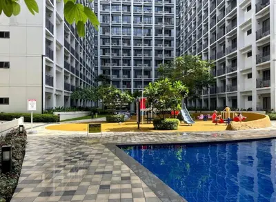 a courtyard with a playground in front of a tall building at Twin Unit at Shore 2 Residences in Manila