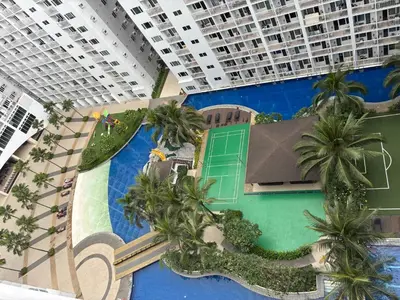 an overhead view of a resort with palm trees and a pool at Haven's Suites a place like home in Manila
