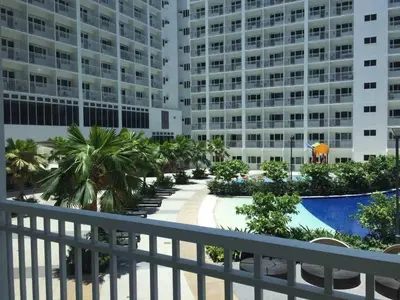 a balcony view of a resort with a pool and buildings at Haven's Suites a place like home in Manila