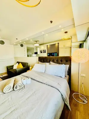 a bedroom with a large bed with two towels on it at Sea Residences in Manila