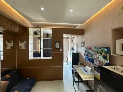 a living room with brown walls and a table at Jeric Place Staycation in Manila