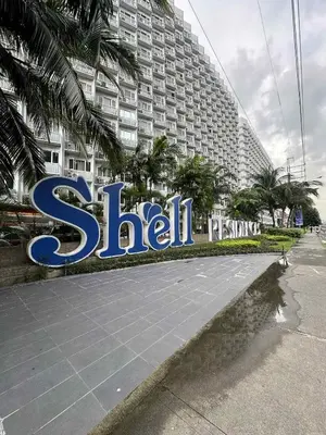 a large sign in front of a large building at Jeric Place Staycation in Manila