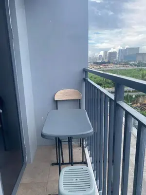 a blue table and a stool on a balcony at Mall of Asia Netflix Disney WIFI IKEA ARENA NAIA SHORE2 418 in Manila
