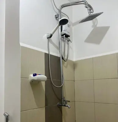 a shower in a bathroom with a shower head at Taguig Condo Unit - Grace Residences by Jenn in Manila