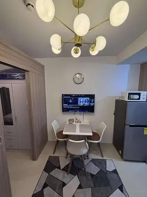 a dining room with a table and a clock on the wall at Shore 2 Tower 1 MOA MallofAsia ARENA IKEA NAIA 685 in Manila