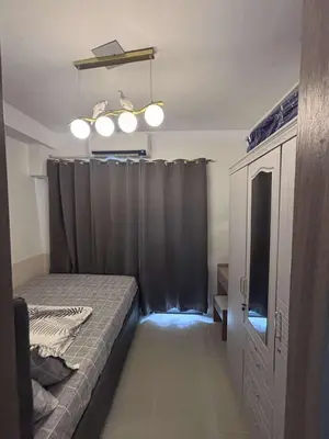 a bedroom with a bed and a black curtain at Shore 2 Tower 1 MOA MallofAsia ARENA IKEA NAIA 685 in Manila